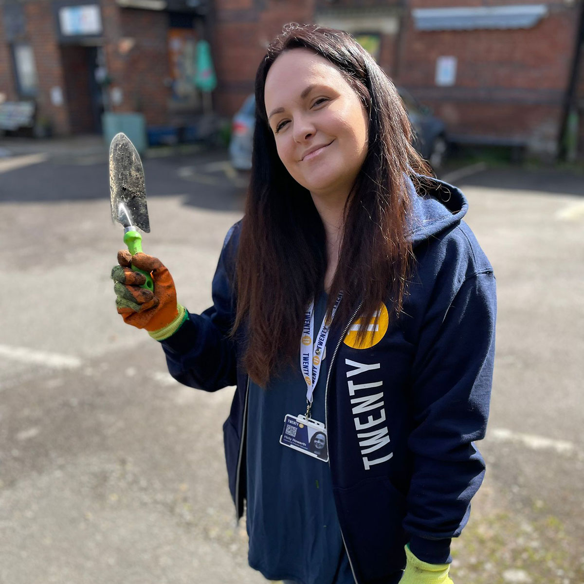 A member of the Twenty11 team holding up a trowel