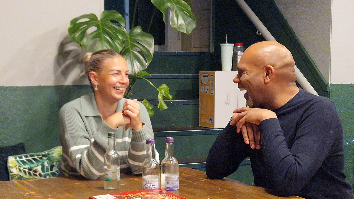 A tenant talking with a Twenty11 staff member at the Realising Potential event